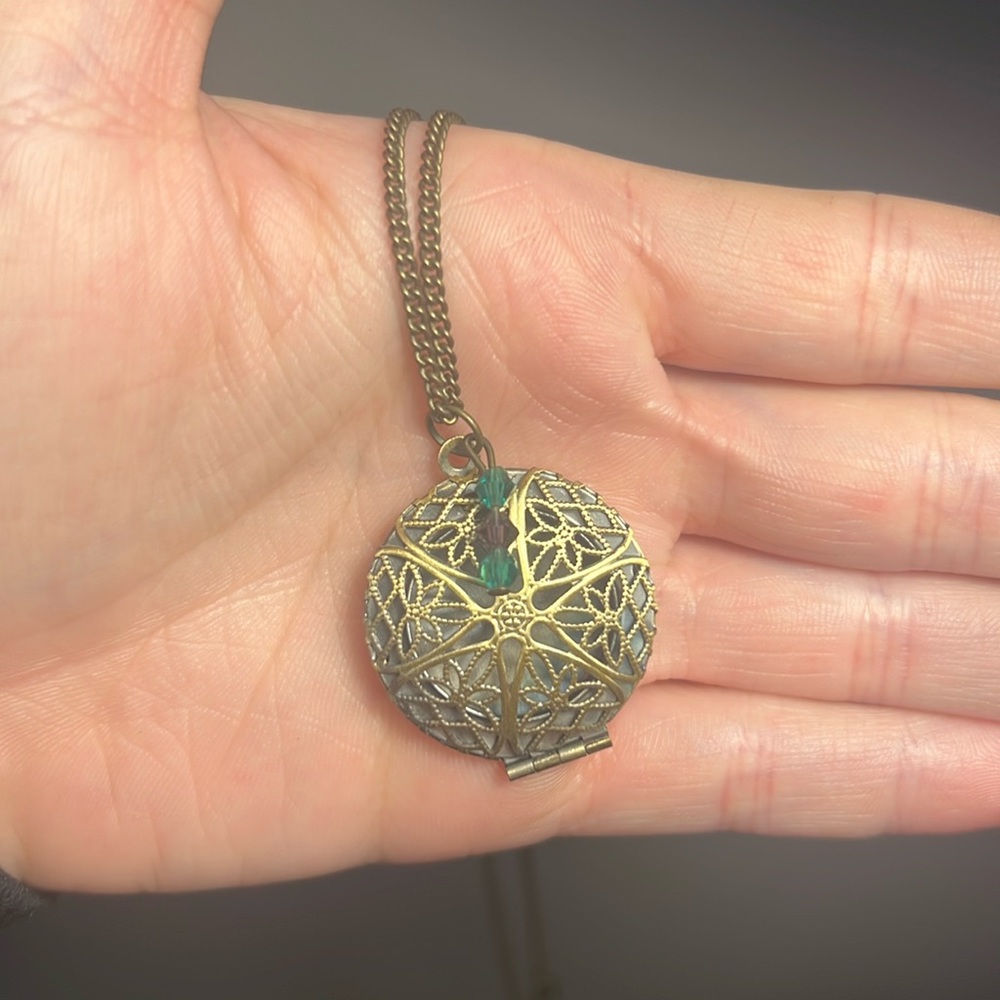 Gold diffuser locket necklace with teal and purple Swarovski crystals